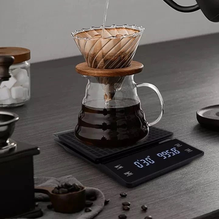 Pour-over coffee brewing on the digital scale with timer